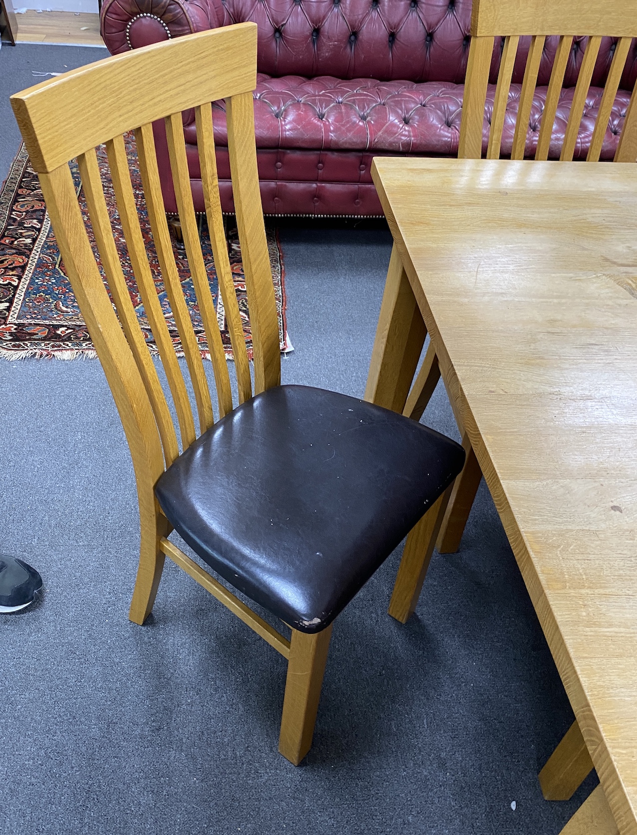 A large contemporary rectangular oak dining table, length 330cm, depth 119cm, height 76cm, and fourteen associated wavy bar back dining chairs.